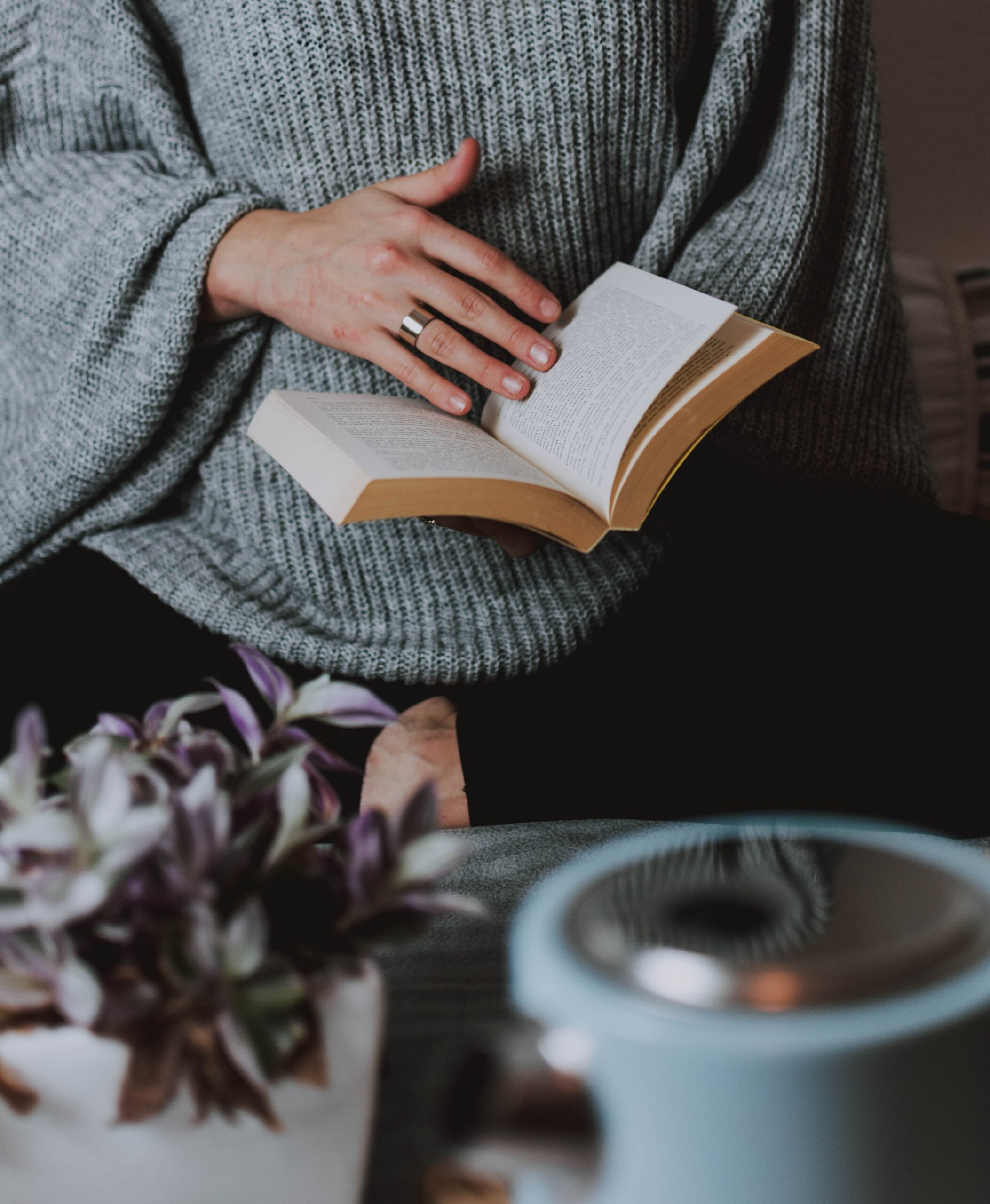 grey sweater girl with book